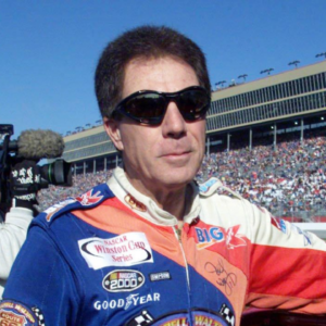 Darrell Waltrip munches on an energy bar before the start of his final NASCAR race after 28 years of racing. The race is the NAPA 500 at the Atlanta Motor Speedway Nov. 20, 2000.