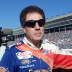 Darrell Waltrip munches on an energy bar before the start of his final NASCAR race after 28 years of racing. The race is the NAPA 500 at the Atlanta Motor Speedway Nov. 20, 2000. Title Waltrip S Final Race