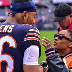 Chicago Bears defensive back Jonathan Owens (36) is greeted by wife and United States gymnast Simone Biles before the game against the Green Bay Packers at Soldier Field.