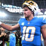 Los Angeles Chargers quarterback Justin Herbert (10) celebrates as he leaves the field after defeating the Denver Broncos at SoFi Stadium.