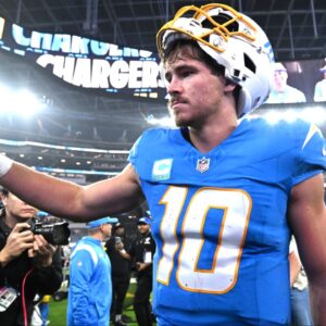 Los Angeles Chargers quarterback Justin Herbert (10) celebrates as he leaves the field after defeating the Denver Broncos at SoFi Stadium.