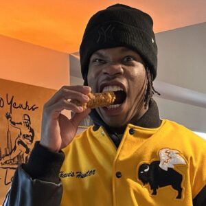 Travis Hunter with a chicken wing.