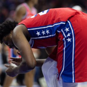 Philadelphia 76ers center Joel Embiid (21) grabs his face after a collision during the second quarter at Wells Fargo Center.