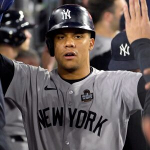 Oct 26, 2024; Los Angeles, California, USA; New York Yankees outfielder Juan Soto (22) celebrates in the dugout after scoring on an RBI single by designated hitter Giancarlo Stanton (not pictured) in the ninth inning against the Los Angeles Dodgers during game two of the 2024 MLB World Series at Dodger Stadium.