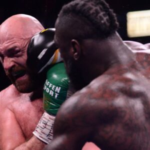 Deontay Wilder (red/black trunks) and Tyson Fury (black/gold trunks) box during their WBC/Lineal heavyweight championship boxing match at T-Mobile Arena.