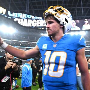 Los Angeles Chargers quarterback Justin Herbert (10) celebrates as he leaves the field after defeating the Denver Broncos at SoFi Stadium.