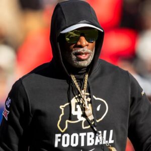 Kansas City, Missouri, USA; Colorado head coach Deion Sanders watches his players warmup prior to the game between the Kansas Jayhawks and the Colorado Buffaloes at GEHA Field at Arrowhead Stadium