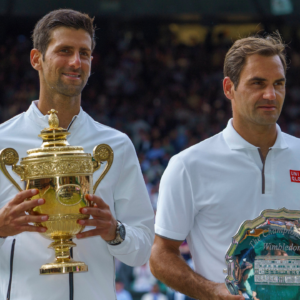 Novak Djokovic (SRB) poses with Roger Federer (SUI) after the mens final on day 13 at the All England Lawn