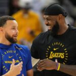 Golden State Warriors guard Stephen Curry (left) and Los Angeles Lakers forward LeBron James (right) talk before the game at Chase Center.