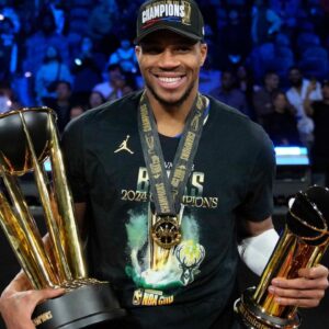 Milwaukee Bucks forward Giannis Antetokounmpo (34) celebrates with the most valuable player and championship trophies after winning the Emirates NBA Cup championship game against the Oklahoma City Thunder at T-Mobile Arena.