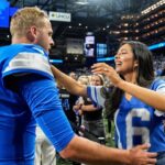 Detroit Lions quarterback Jared Goff hugs his wife Christen Harper during warmups before the Los Angeles Rams game at Ford Field in Detroit on Sunday, Sept. 8, 2024.