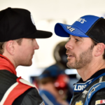 NASCAR Sprint Cup Series driver Jimmie Johnson (right) talks with Kurt Busch during practice for the Ford EcoBoost 400 at Homestead-Miami Speedway.