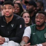 Milwaukee Bucks forward Giannis Antetokounmpo (l) and his brother Milwaukee Bucks forward Thanasis Antetokounmpo (r) watch the game from the bench in the fourth quarter against the New York Knicks at Madison Square Garden