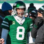 Dec 22, 2024; East Rutherford, New Jersey, USA; New York Jets quarterback Aaron Rodgers (8) talks with head coach Jeff Ulbrich during the first half against the Los Angeles Rams at MetLife Stadium.