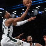 Milwaukee Bucks forward Giannis Antetokounmpo (34) drives to the basket while being defended by Brooklyn Nets forward Dorian Finney-Smith (28) and Brooklyn Nets center Nic Claxton (33) during the second half at Barclays Center.