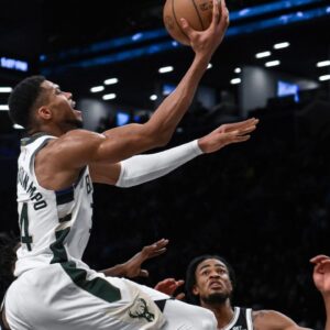 Milwaukee Bucks forward Giannis Antetokounmpo (34) drives to the basket while being defended by Brooklyn Nets forward Dorian Finney-Smith (28) and Brooklyn Nets center Nic Claxton (33) during the second half at Barclays Center.