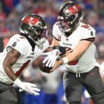 ampa Bay Buccaneers quarterback Baker Mayfield (6) hands the ball to running back Rachaad White (1) in the first quarter against the Buffalo Bills at Highmark Stadium.