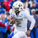 Nov 23, 2024; Kansas City, Missouri, USA; Colorado quarterback Shedeur Sanders (2) scrambles for yardage during the 2nd quarter between the Kansas Jayhawks and the Colorado Buffaloes at GEHA Field at Arrowhead Stadium.