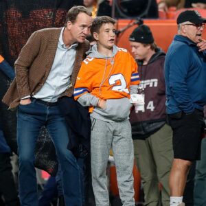 Former Denver Broncos player Peyton Manning with his son Marshall before the game against the Cleveland Browns at Empower Field at Mile High.
