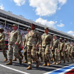 May 26, 2019; Concord, NC, USA; Service men and women of the U.S. Army March on the track prior to the Coca-Cola 600 at Charlotte Motor Speedway. Mandatory Credit: Jasen Vinlove-Imagn Images