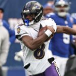 Dec 15, 2024; East Rutherford, New Jersey, USA; Baltimore Ravens quarterback Lamar Jackson (8) carries the ball during the first half against the New York Giants at MetLife Stadium.
