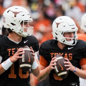 Texas Longhorns quarterbacks Arch Manning (16), left, and Quinn Ewers (3) throw passes while warming up ahead of the Longhorns' spring Orange and White game at Darrell K Royal Texas Memorial Stadium in Austin, Texas