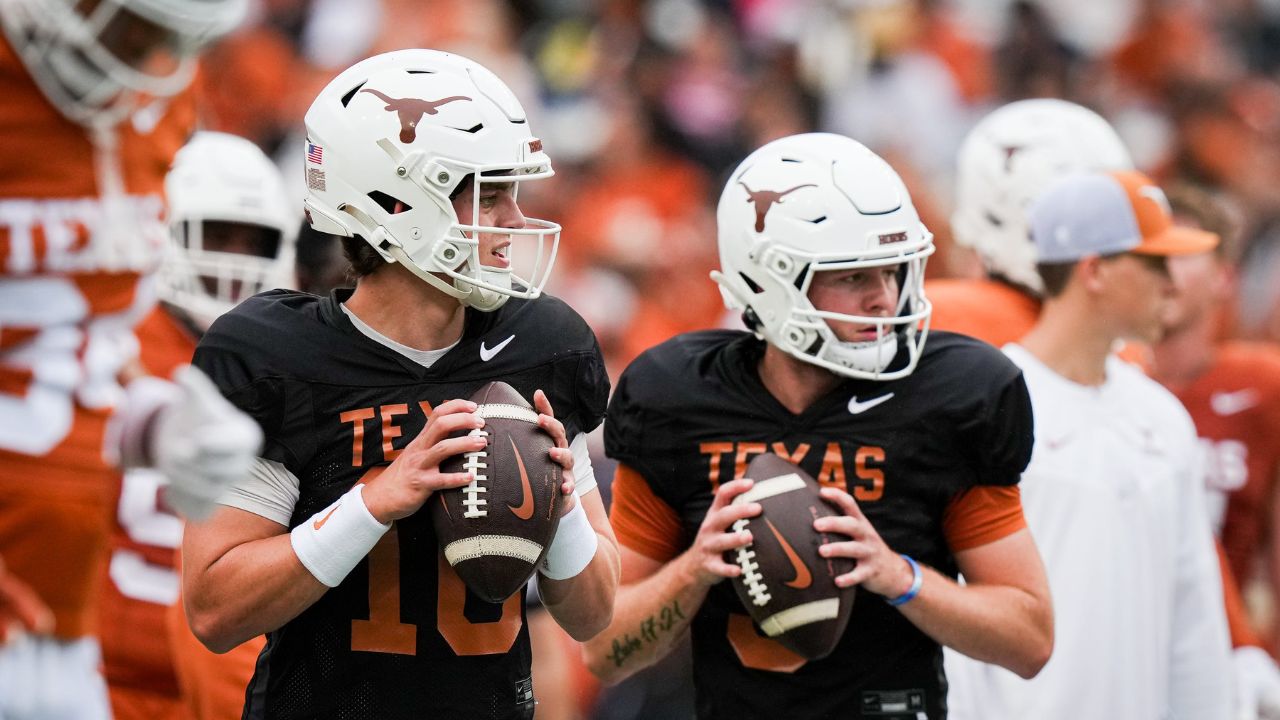 Texas Longhorns quarterbacks Arch Manning (16), left, and Quinn Ewers (3) throw passes while warming up ahead of the Longhorns' spring Orange and White game at Darrell K Royal Texas Memorial Stadium in Austin, Texas