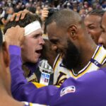 Los Angeles Lakers guard Austin Reaves (center left) is congratulated by forward LeBron James (center right) after making the game-winning basket to defeat the Golden State Warriors at Chase Center
