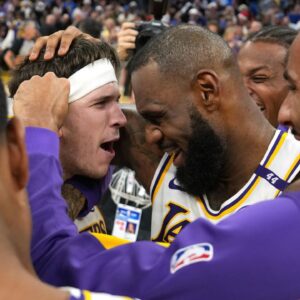 Los Angeles Lakers guard Austin Reaves (center left) is congratulated by forward LeBron James (center right) after making the game-winning basket to defeat the Golden State Warriors at Chase Center