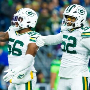 Dec 15, 2024; Seattle, Washington, USA; Green Bay Packers linebacker Edgerrin Cooper (56) celebrates with defensive end Rashan Gary (52) following a sack against the Seattle Seahawks during the first quarter at Lumen Field.