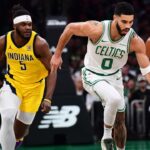 Boston Celtics forward Jayson Tatum (0) dribbles the ball up the court past Indiana Pacers forward Jarace Walker (5) during the first half at TD Garden.