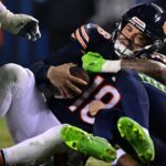 Chicago Bears quarterback Caleb Williams (18) is sacked by Seattle Seahawks defensive back Rayshawn Jenkins (2) during the fourth quarter at Soldier Field.