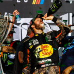 NASCAR Cup Series driver Martin Truex Jr. (78) celebrates with champagne after winning the NASCAR Cup Championship and the Ford EcoBoost 400 at Homestead-Miami Speedway.