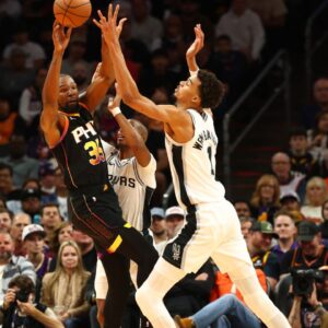 Dec 3, 2024; Phoenix, Arizona, USA; Phoenix Suns forward Kevin Durant (35) against San Antonio Spurs center Victor Wembanyama (1) in the first half of an NBA Cup game at Footprint Center. Mandatory Credit: Mark J. Rebilas-Imagn Images