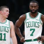 Boston Celtics forward Jaylen Brown (7) and Boston Celtics guard Payton Pritchard (11) talk during the first half against the Memphis Grizzlies at TD Garden.