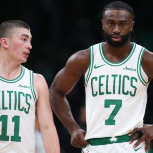 Boston Celtics forward Jaylen Brown (7) and Boston Celtics guard Payton Pritchard (11) talk during the first half against the Memphis Grizzlies at TD Garden.