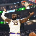Los Angeles Lakers forward LeBron James (23) gestures after dunking against the Golden State Warriors during the first quarter at Chase Center.