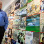 Rick Hendrick pauses to look at the wall of photos that line the trailer from his late son, Ricky Hendrick's race team on display inside the 58,000-square foot Heritage Center in Concord, North Carolina.