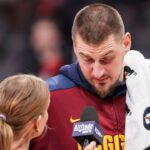 Denver Nuggets center Nikola Jokic (15) reacts while being interviewed after the game against the Atlanta Hawks during the second half at State Farm Arena.