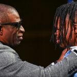 Colorado Buffaloes wide receiver/cornerback Travis Hunter with head coach Deion Sanders after winning the 2024 Heisman Trophy.