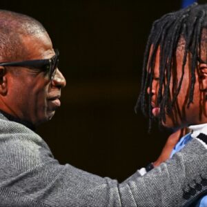 Colorado Buffaloes wide receiver/cornerback Travis Hunter with head coach Deion Sanders after winning the 2024 Heisman Trophy.