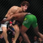 Movsar Evloev (red gloves) fights Aljamain Streling (blue gloves) at T-Mobile Arena.