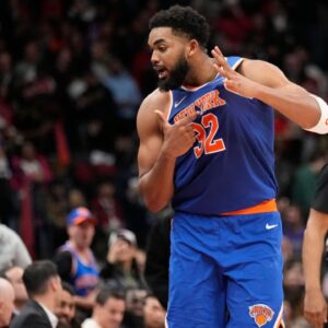 Knicks center Karl-Anthony Towns (32) taunts the Toronto Raptors fans after making a three point basket to clinch a win near the end of the fourth quarter at Scotiabank Arena.