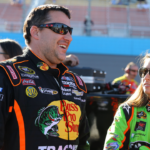 NASCAR Sprint Cup Series driver Tony Stewart (left) talks with teammate Danica Patrick during qualifying for the Subway Fresh Fit 500 at Phoenix International Raceway.