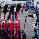 May 29, 2023; Concord, North Carolina, USA; Sunoco fuel crews ready team gas cans before the start during the Coca-Cola 600 at Charlotte Motor Speedway. Mandatory Credit: Jim Dedmon-Imagn Images