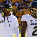Colorado Buffaloes head coach Deion Sanders with son and quarterback Shedeur Sanders (2) against the Arizona State Sun Devils at Mountain America Stadium.