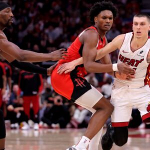 Miami Heat guard Tyler Herro (14) handles the ball against Houston Rockets guard Amen Thompson (1) during the fourth quarter at Toyota Center.