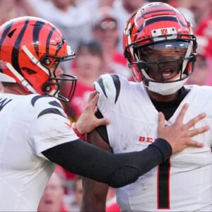 Cincinnati Bengals quarterback Joe Burrow (9) restrains wide receiver Ja'Marr Chase (1) after an altercation with officials during the second half of the game against the Kansas City Chiefs at GEHA Field at Arrowhead Stadium.