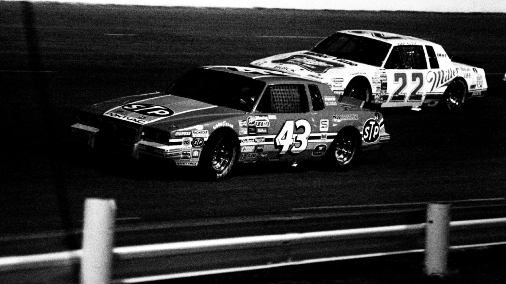Driver Richard Petty (43) battles Bobby Allison (22) around the Nashville International Raceway oval during early action of the Nashville Coors 420 on May 12, 1984. A record crowd of 22,504 fans watch the NASCAR Winston Cup race.