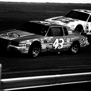 Driver Richard Petty (43) battles Bobby Allison (22) around the Nashville International Raceway oval during early action of the Nashville Coors 420 on May 12, 1984. A record crowd of 22,504 fans watch the NASCAR Winston Cup race.